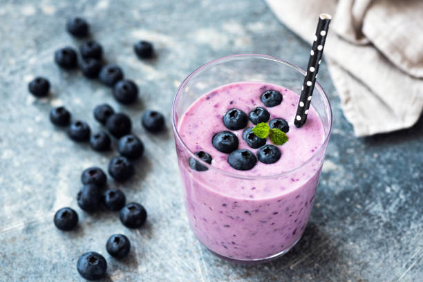 Tasty blueberry smoothie in glass. Healthy refreshing drink, vegan and vegetarian diet food concept